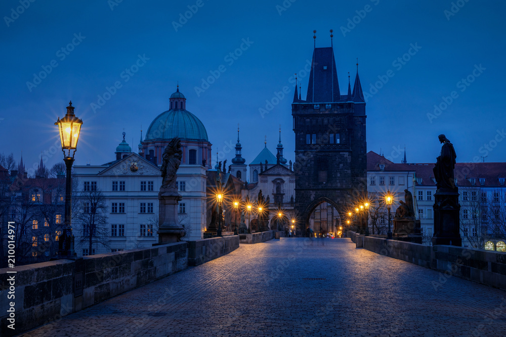 The Old Town with Charles bridge in Prague early in the morning with light of city lamps