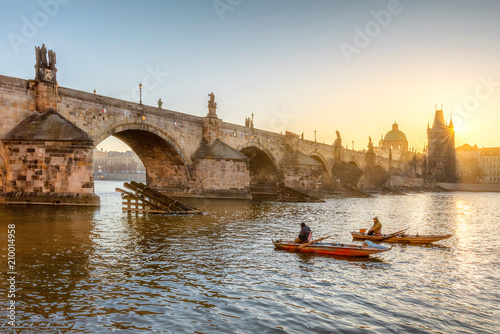 Two fishermen under the Charles bridge in Prague at the morning.