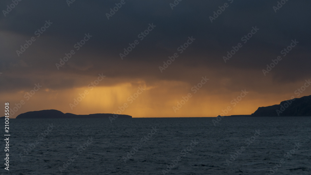 Dramatic colourful and stormy sunset over the Sound of Sunda with the Island of Sunda and the Mull of Kintyre, Scotland