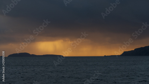 Dramatic colourful and stormy sunset over the Sound of Sunda with the Island of Sunda and the Mull of Kintyre, Scotland