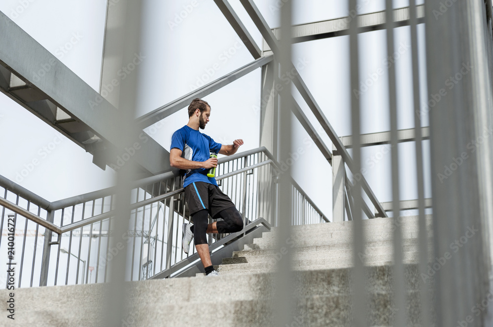 Man on stairs having a break from running