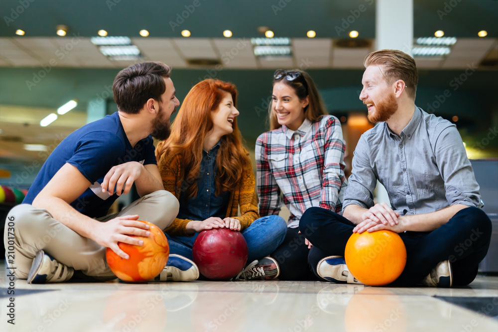 Fototapeta premium Friends enjoying bowling at club