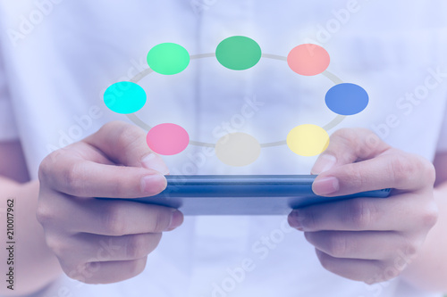 Young people using cell phone with colorful circle digital icon