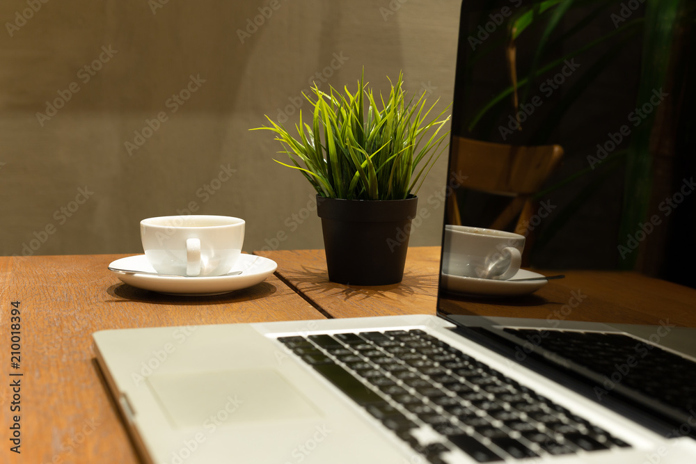 Fototapeta premium Business still life selected coffee cup with laptop on wooden table