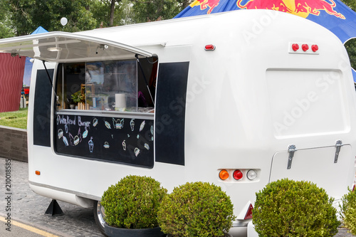 White trailer for selling food is standing in the street in anticipation of buyers