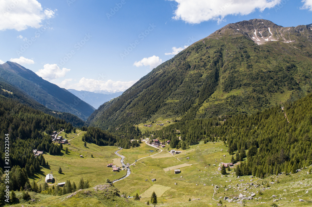 Naklejka premium Green valley and forest in Valtellina. Valgrosina. Province of Sondrio, aerial shot