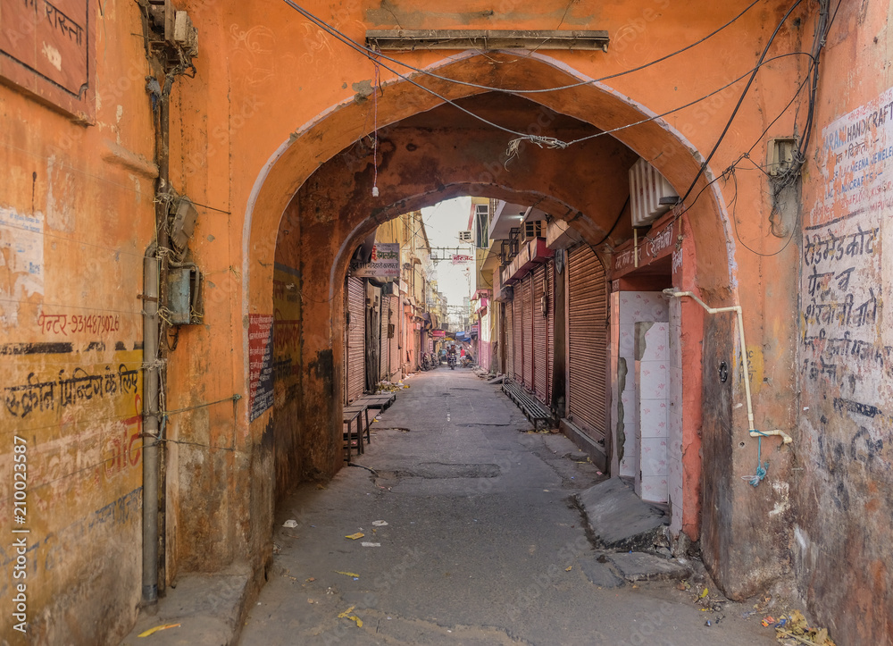 Jaipur, Rajastan, India - April 1, 2018: A lonely and narrow street in the center of the pink city of Jaipur
