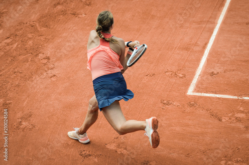 Backhand swing of woman playing tennis photo