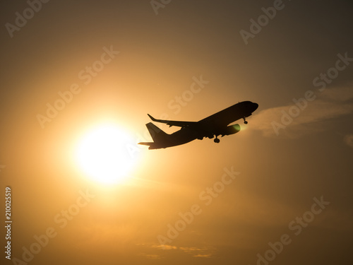 Airplane silhouette with sun