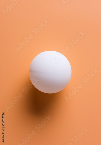 Table tennis ball on yellow background