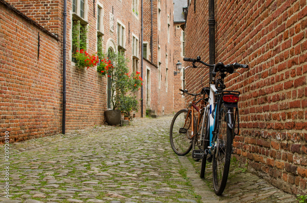 View on old belgian street with brick house and bicycles in Groot Begijnhof Leuven