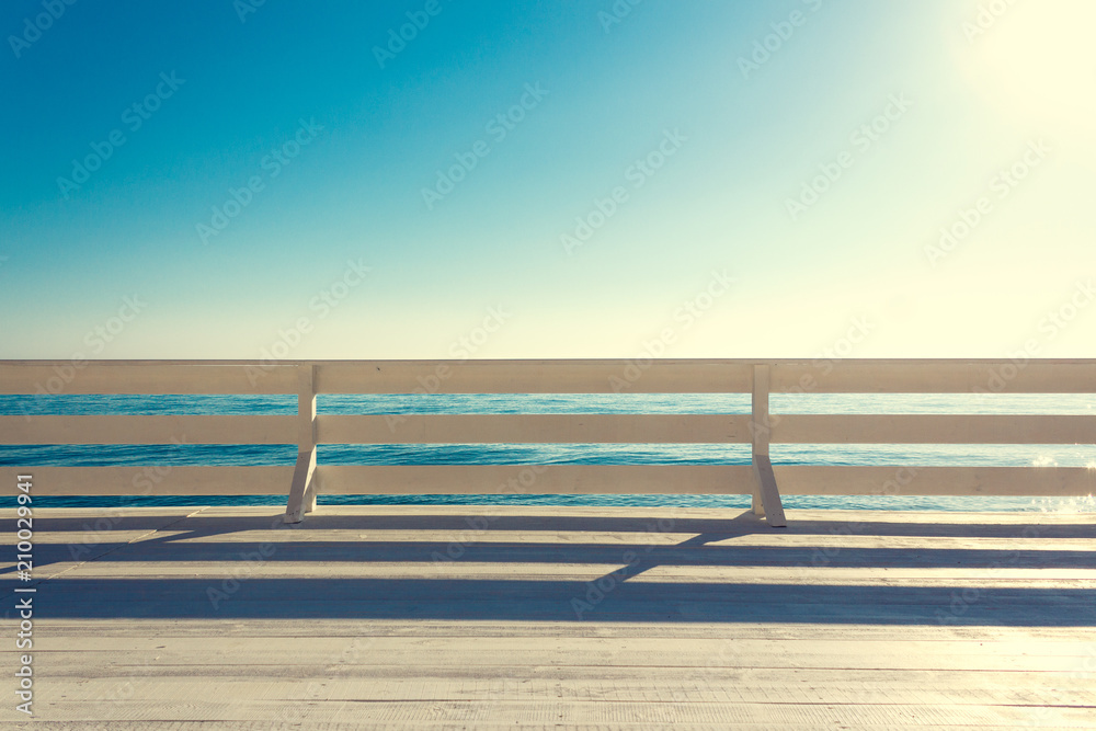 White wooden promenade by the sea. Minimalistic travel concept.