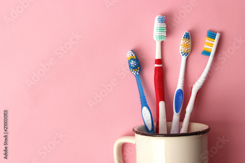 toothbrushes in a glass on a colored background. oral health, brush your teeth, healthy teeth