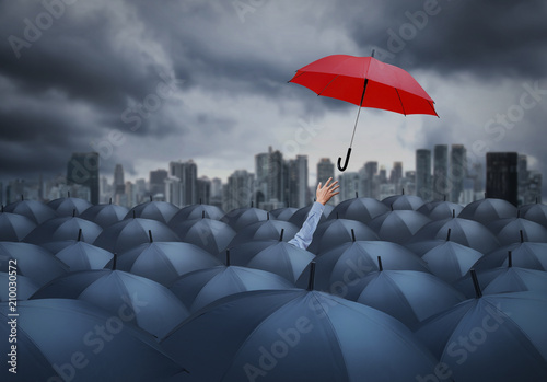 businessman with red umbrella among others, unique different concept