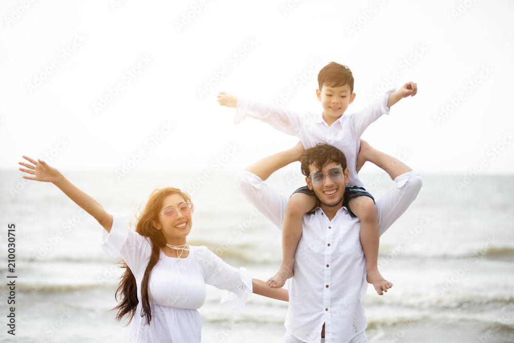 Active parents and people outdoor activity on summer vacations and holiday with children.Happy family and son walk with fun of sunset sea on sand beach. Active parents and people outdoor activity on summer vacations and holiday with children.Happy family and son walk with fun of sunset sea on sand beach.