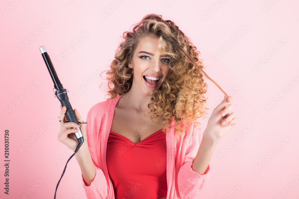 Smiling curly hair girl holds hairdresser equipment. Hairdresser. Beauty and style. Beauty industry profession. Makeup and cosmetics for skincare. Isolated on white background. Smiling curly hair girl holds hairdresser equipment. Hairdresser. Beauty and style. Beauty industry profession. Makeup and cosmetics for skincare. Isolated on white background.
