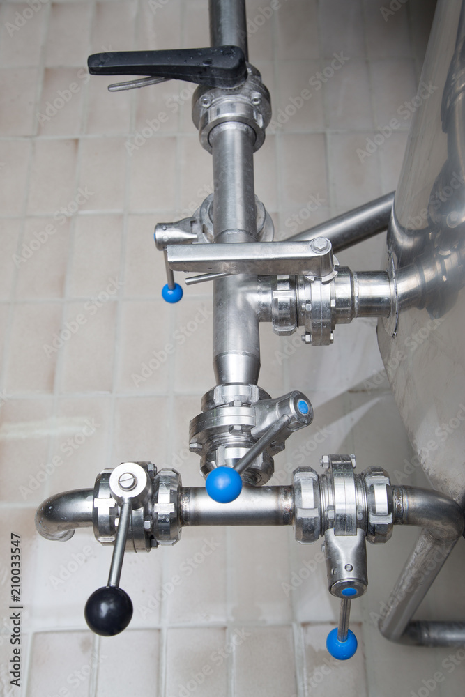 Metallic Stainless Steel Pipes In Modern Dairy Plant Closeup Metallic Stainless Steel Pipes In Modern Dairy Plant Closeup