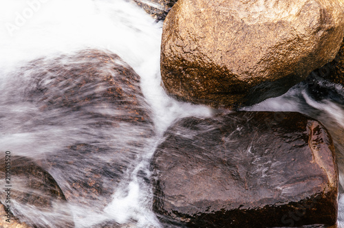 Tropical river flowing rapid water and rocks landscape photo