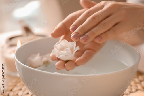 Young woman undergoing spa manicure treatment in beauty salon  closeup