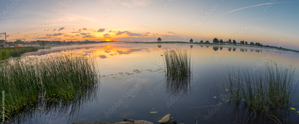 Sunrise above a river on foggy summer morning, Spherical panorama of beautiful European landscape
