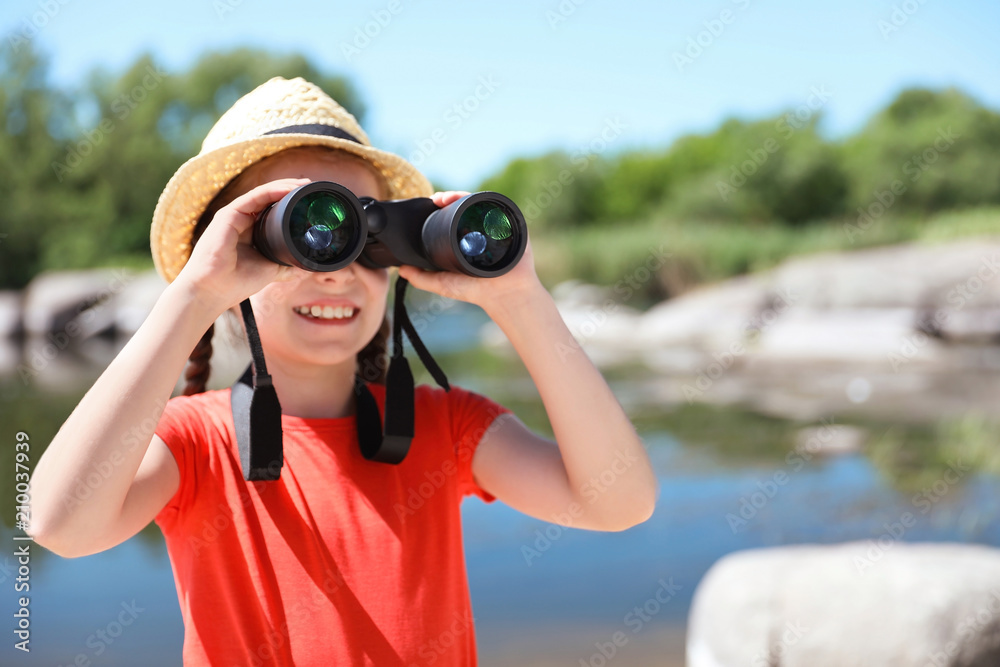 Little girl with binoculars outdoors. Summer camp Little girl with binoculars outdoors. Summer camp