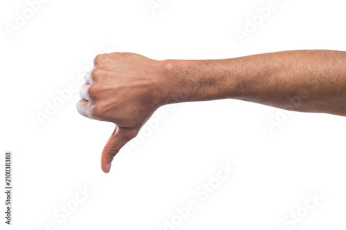 Black male hand gesturing thumb down, isolated on white