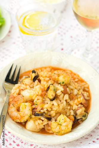 Italian rice dish risotto with seafood, shrimps and mussels