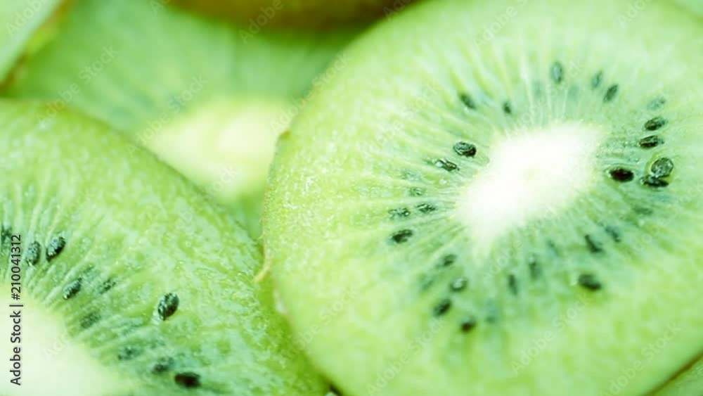Slice of juicy fresh kiwi fruit rotates as background Slice of juicy fresh kiwi fruit rotates as background