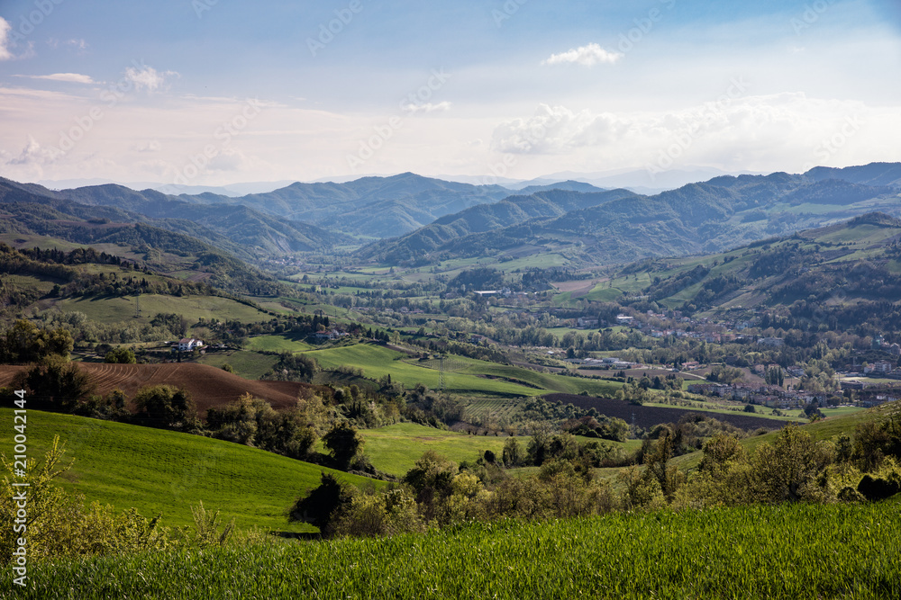 View of Tuscany valley with farms and hills
