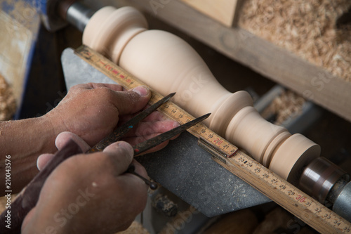 Carpenter turning hard wood on a lathe  hands close up