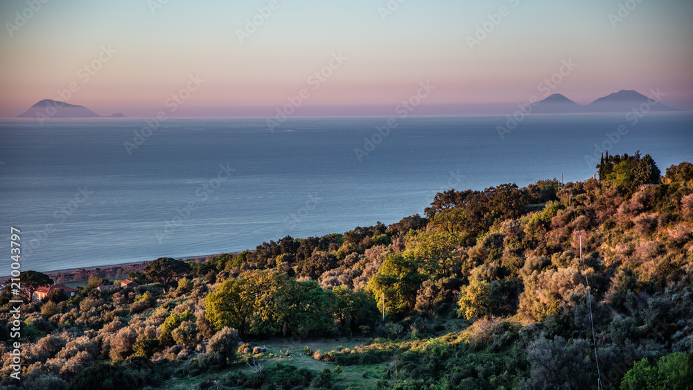 View of Aeolian islands from the sicilian coast at sunset