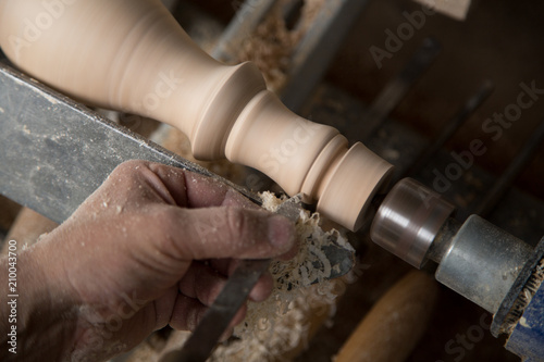 Carpenter turning hard wood on a lathe  hands close up