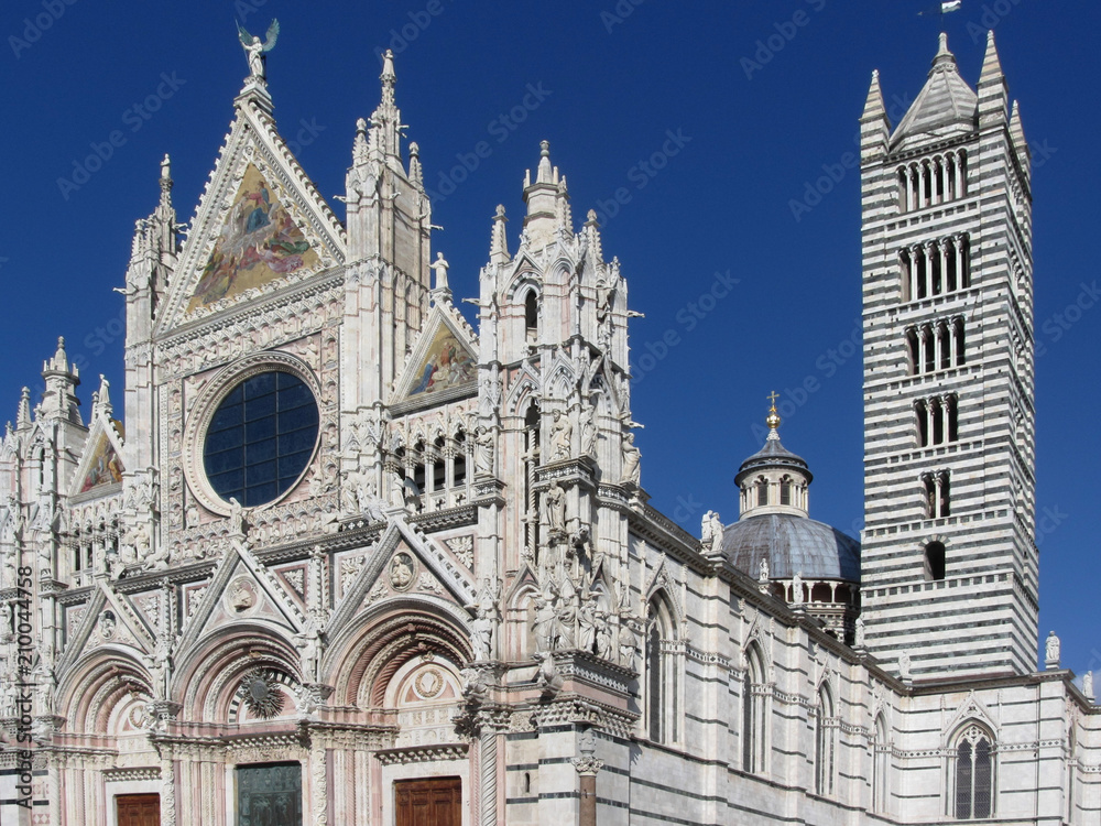 The metropolitan cathedral of Saint Mary of the Assumption against the blue sky . Tuscany, Italy