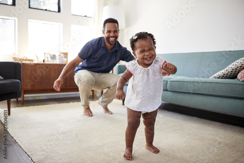 Принти на полотні Baby Daughter Dancing With Father In Lounge At Home
