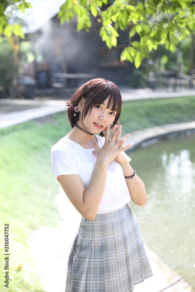 Portrait beautiful asian girl looking and smile in nature leaves outdoor Portrait beautiful asian girl looking and smile in nature leaves outdoor