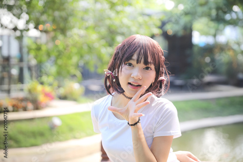 Portrait beautiful asian girl shouting and smile in nature leaves outdoor
