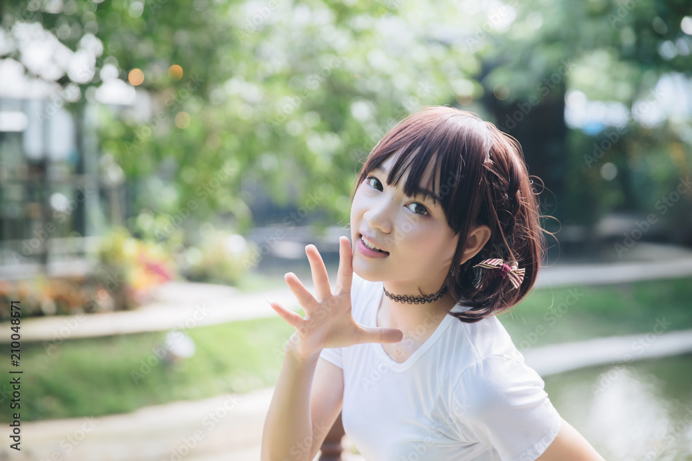 Asian girl portrait looking in nature tree background Asian girl portrait looking in nature tree background