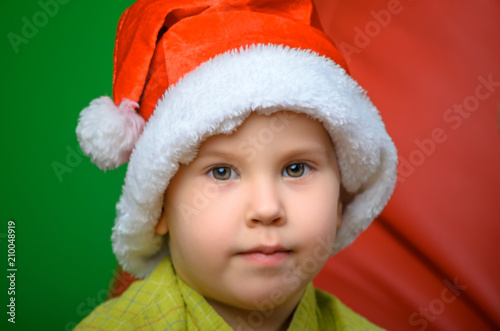 portrait of a young guy in the hat of Santa Claus
