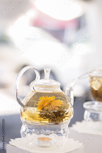 Chrysanthemum tea. Selective focus of chrysanthemum tea in a transparent glass teapot.