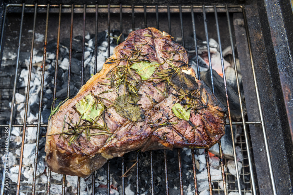 Whole T-Bone steak cooking on grill