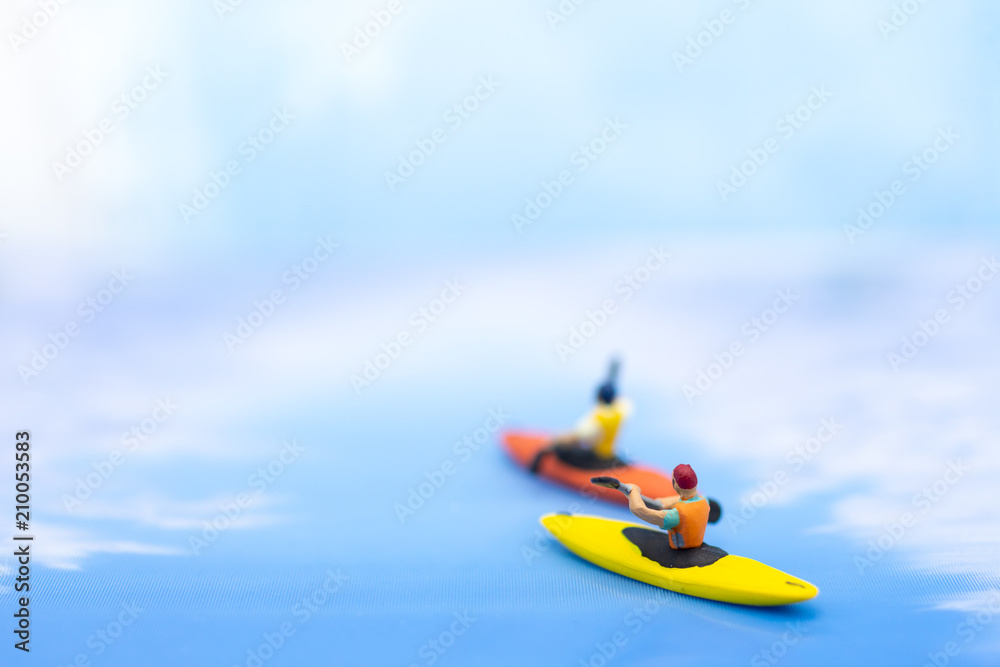 Miniature people : Traveler boating, kayaking in the ocean. Image use for Sports and Tourism concept.