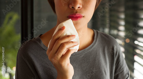 Wallpaper Mural Red lips woman wiping her mouth ,red lips,girl take clean on her lips with white tissue, asian girl using tissue wipe her mouth,girl use napkin,white tissue Torontodigital.ca