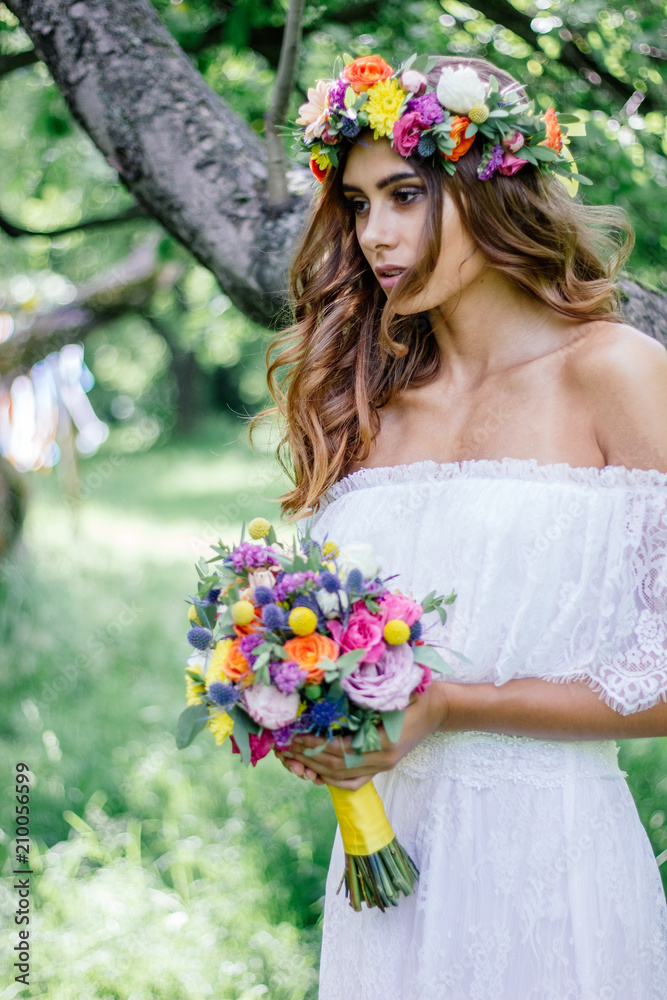 Obraz premium Bride with the wedding bouquet and flower wreast.