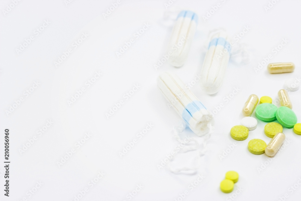 Tampons and pills on a white background Tampons and pills on a white background