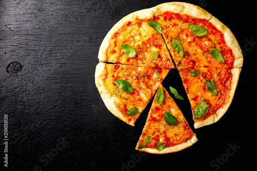 Pizza Margarita with Mozzarella and Basil on the Black Background Bake Snack with Tomatoes Top View Copy space for Text