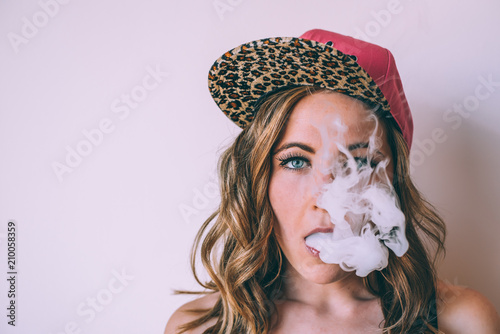 Skater woman smoking a cannabis joint photo