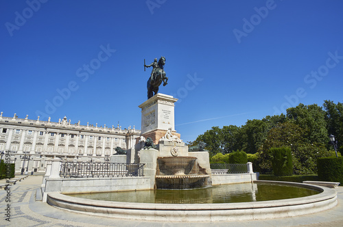 East facade of Royal Palace of Madrid (Palacio Real) with Monument to Felipe IV in foreground.