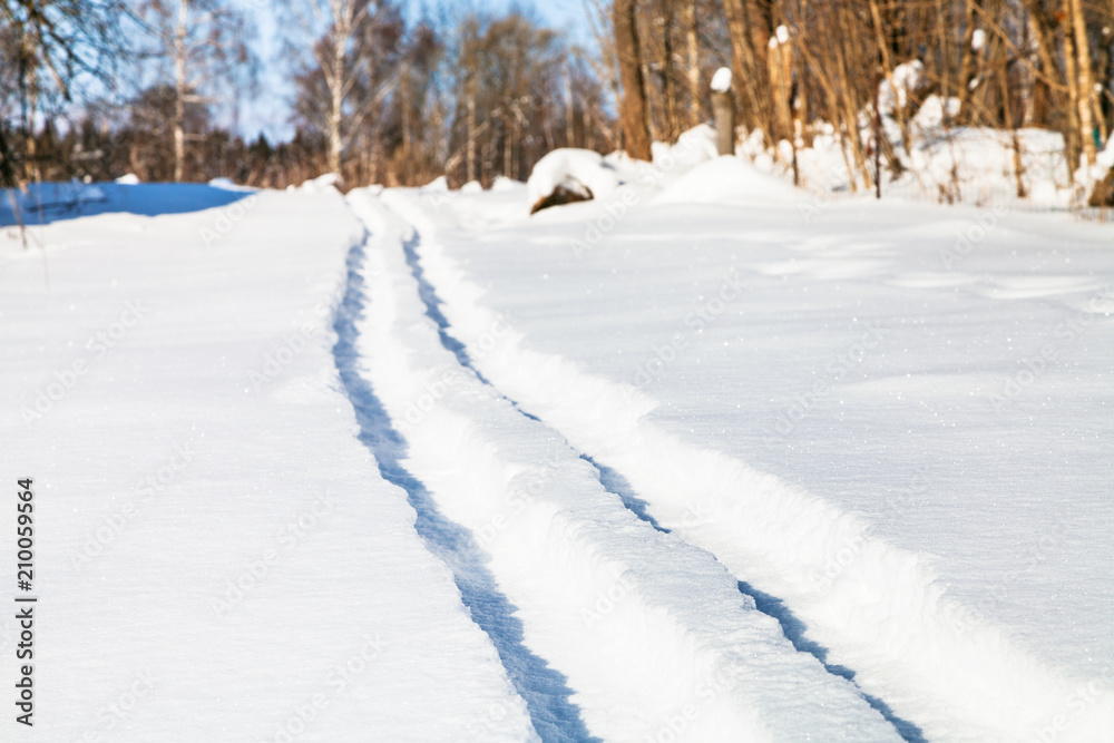 ski track on snow field in sunny winter day ski track on snow field in sunny winter day