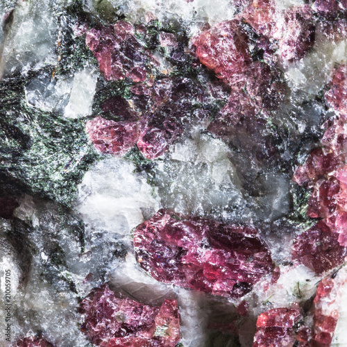 texture of mineral with pink Eudialyte crystals photo