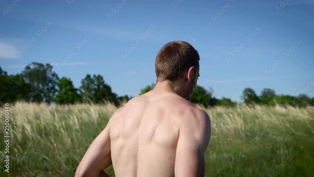 Shot from behind of athletic sportsman running. Shot from behind of athletic sportsman running.